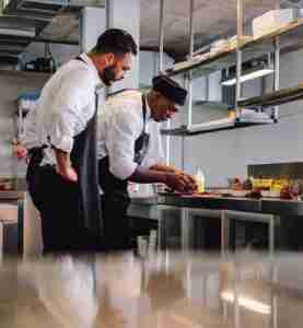 Food Safety - food inspectors checking on the food in a restaurant